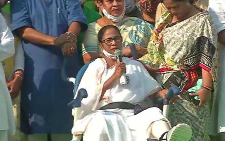 mamata sitting in a wheelchair at a public meeting in purulia